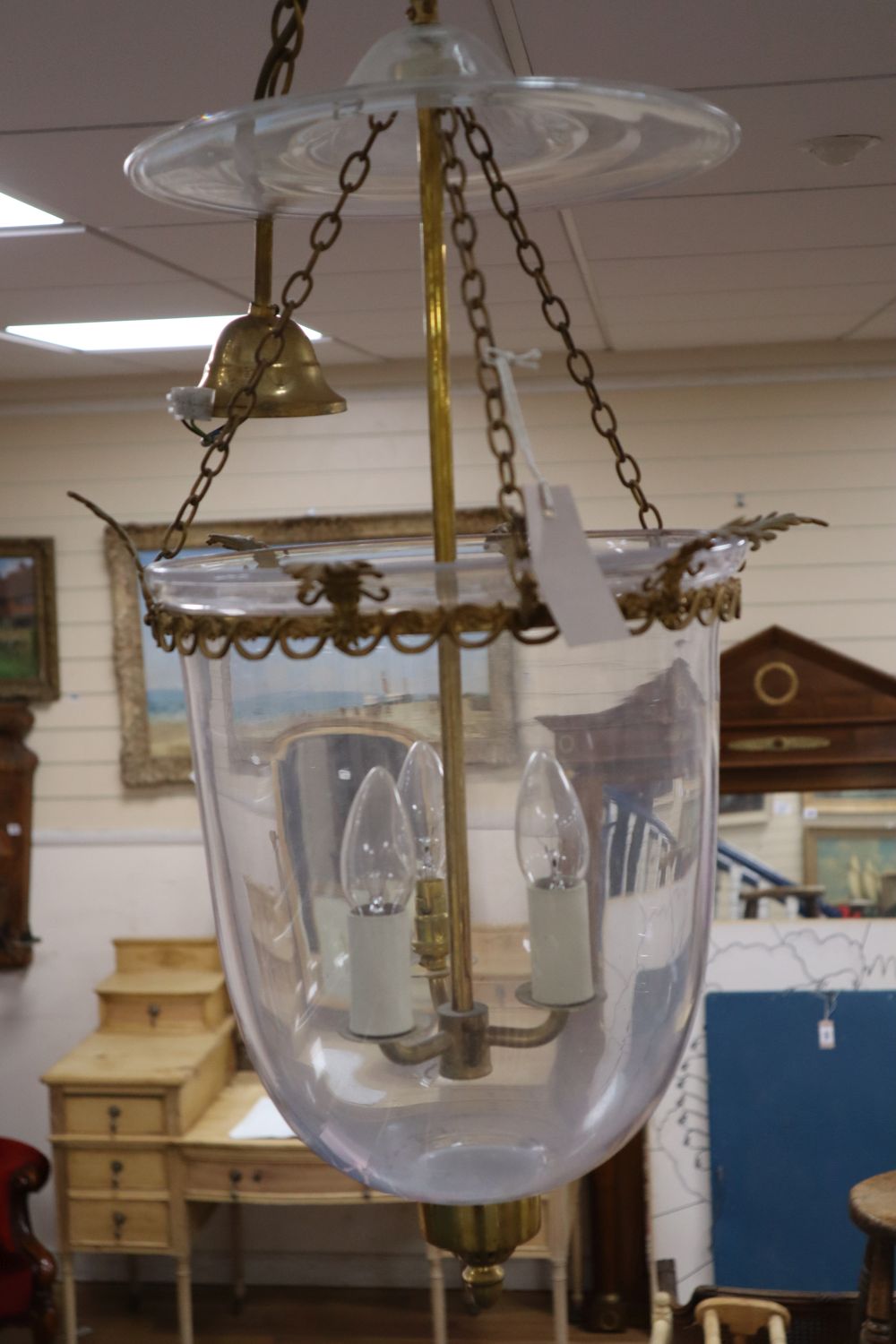 A pair of three light hall lanterns, cast with anthemions, height 63cm